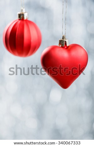 Red Xmas decorations on silver bokeh background. Merry Christmas and Happy New Year card
