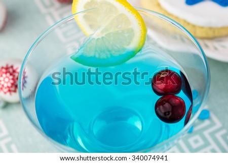 Close up of glass with blue cocktail .