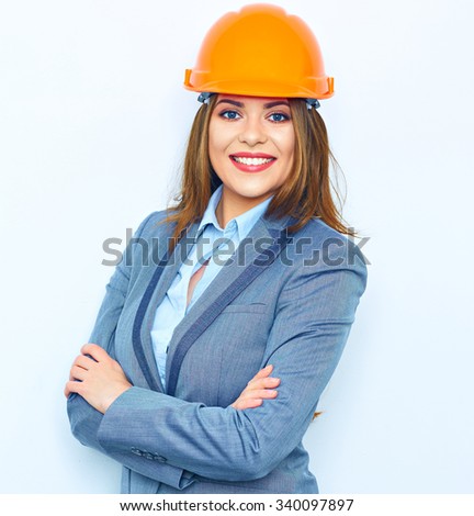 Architect business woman standing against white wall with crossed arms. Young smiling woman. Building helmet.