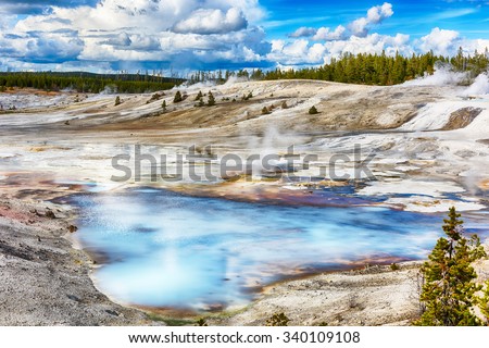 Steaming opaque thermal pools at Norris Geyser Basin. Yellowstone National Park, Wyoming - USA Royalty-Free Stock Photo #340109108