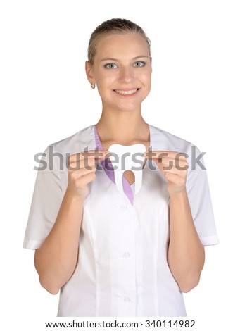 Smiling woman dentist holding a white paper tooth.