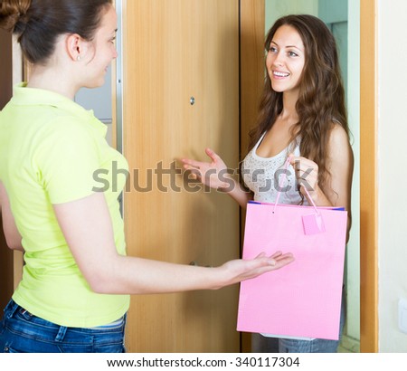 Girl visiting her girlfriend with gift
