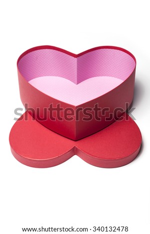 A red empty(blank) heart(love) shape gift box with lid(cover) inside(pink) top view isolated white.