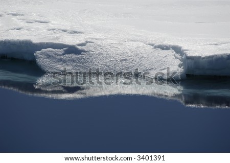 Reflecting edge of an ice floe in sunlight. Picture was taken during a 3-month Antarctic research expedition near the Peninsula.