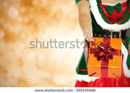 golden blurred background and elf and box 