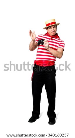 Angry Caucasian man with short black hair in costume using camera - Isolated