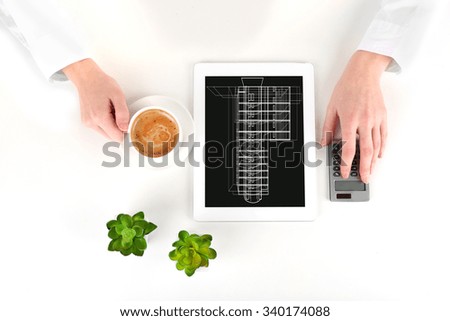 Real estate offer. Businesswoman with design of the building on the tablet