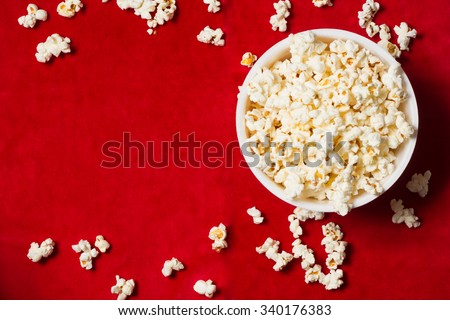 bowl with popcorn on red background. mock up. top view.
