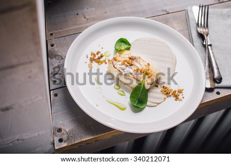 Cod fish fillet (sous vide) with puree in a white plate