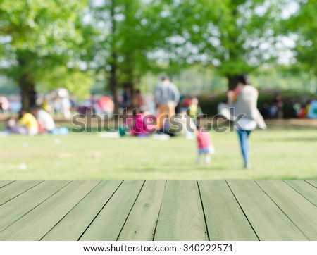 Perspective wood with blurred people activities in park background