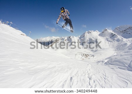 flying snowboarder on mountains. Extreme winter sport