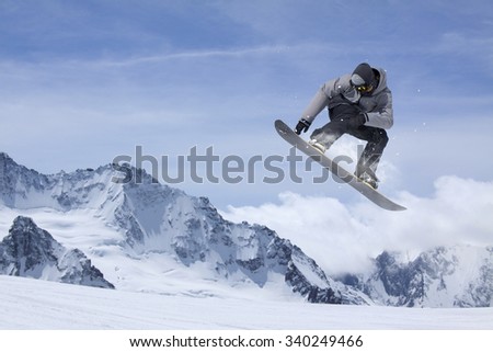 flying snowboarder on mountains. Extreme winter sport Royalty-Free Stock Photo #340249466