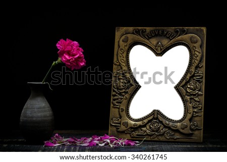 Still life with frame,flowers on rusty background