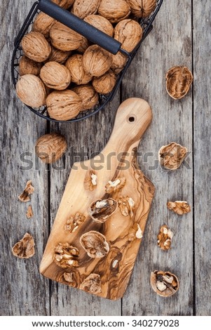Fresh ripe walnuts on a wooden background