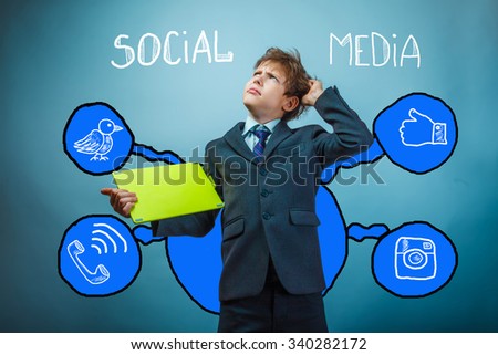 Teen boy businessman scratching his head thinking hand holding a tablet in the hands of social media infographics sketch Internet