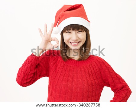 smiling Japanese woman OK gesture on christmas