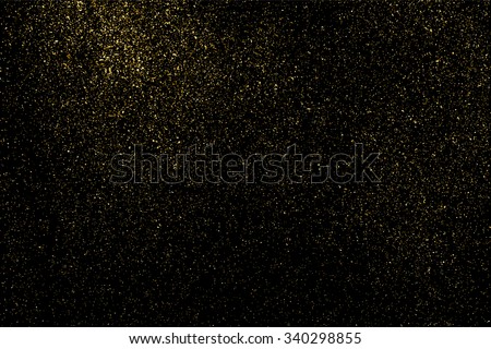 Gold glitter texture on a black background. Holiday background. Golden explosion of confetti. Golden grainy abstract  texture on a black  background. Design element. Vector illustration,eps 10. Royalty-Free Stock Photo #340298855