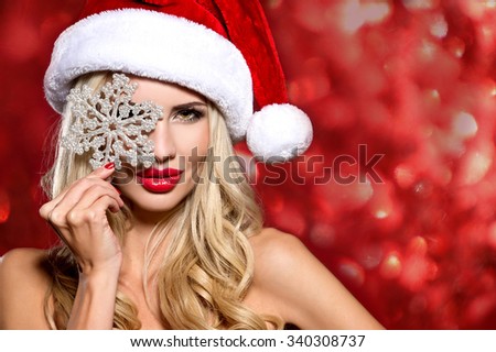 Christmas, x-mas, winter, happiness concept. picture of cheerful santa helper girl with snowflake on bokeh background