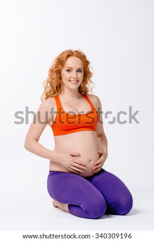 Beautiful pregnant woman in yoga pose