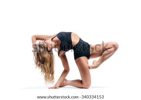 young beautiful modern style dancer posing on a studio background