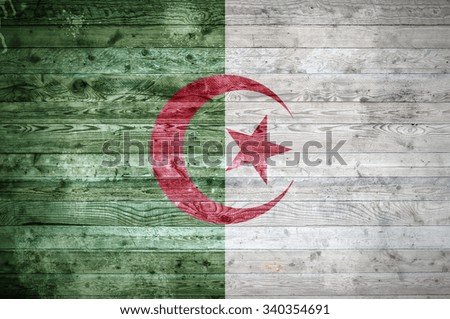 A vignetted background image of the flag of Algeria painted onto wooden boards of a wall or floor.