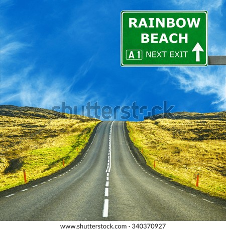 RAINBOW BEACH road sign against clear blue sky