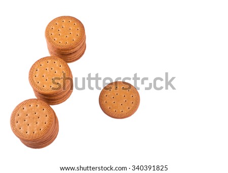 BISCUITS - A stack of delicious round biscuits with a few crumbs isolated on white
