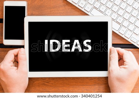 Hands holding tablet pc with ideas 