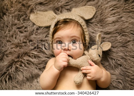Small cute girl playing with her favorite rabbit toy
