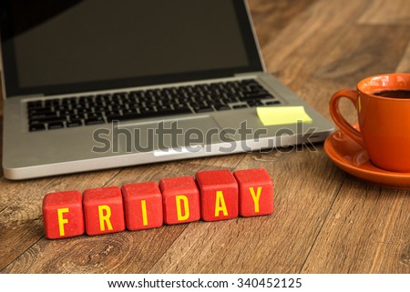 Friday written on a wooden cube in a office desk Royalty-Free Stock Photo #340452125