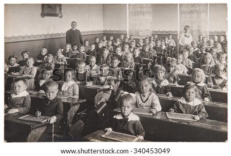Antique portrait of school classmates. Group of children and teachers. Vintage picture with original film grain and blur
