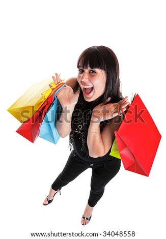 Smiling young woman, dressed Indie style, with shopping bags.  She is happy because of all the great sales!  Shot on white background with wide angle.