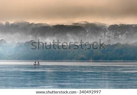 Sangha River. Morning fog on the African river Sangha. Congo. Royalty-Free Stock Photo #340492997