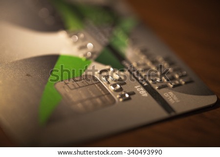 Low key macro shot of credit card on the wood table (Blurred for aesthetic quality)