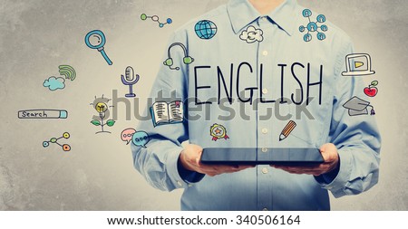English concept with young man holding a tablet computer  Royalty-Free Stock Photo #340506164