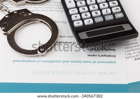 employment contract with handcuffs and calculator