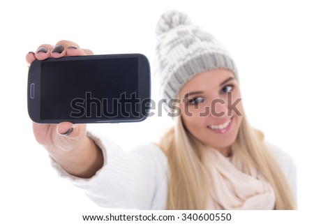 beautiful woman in winter clothes taking selfie photo with smartphone isolated on white background