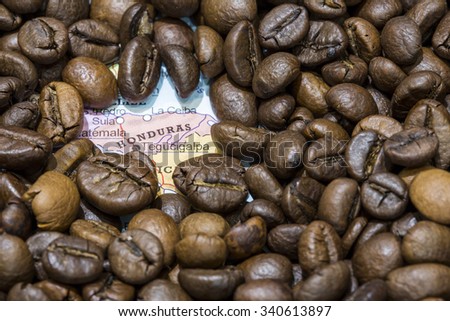 Geographical map of Honduras covered by a background of roasted coffee beans. This nation is between the ten main producers and exporters of coffee. Horizontal image.