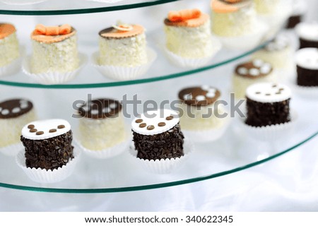 Decorated colorful cupcakes on a glass plate