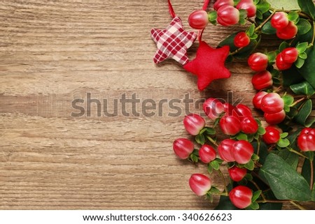 Christmas wallpaper with hypericum on wooden background, copy space