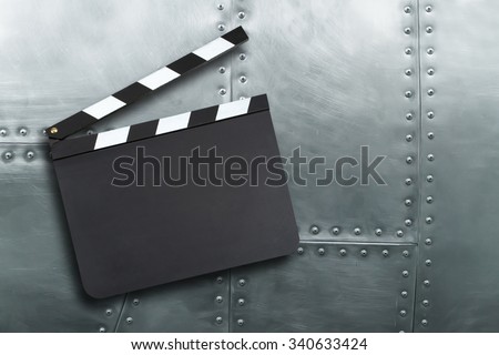 Blank movie production clapper board on vintage metal background