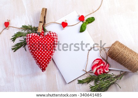 Love Valentine's hearts natural cord and red clips on rustic texture background, copy space