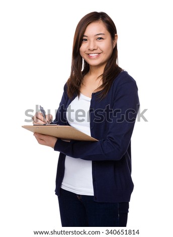 Young Woman take note on clipboard