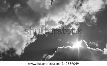 in the sky the sun breaks through the clouds. Black and white photo