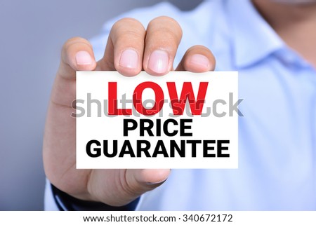 LOW PRICE GUARANTEE, message on the card shown by a man