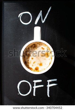 Coffee on a black board with on and off written on the boards with chalk