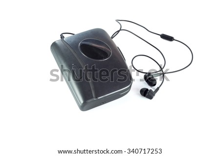 Old fashioned music of cassette player and black earphones isolated on white background