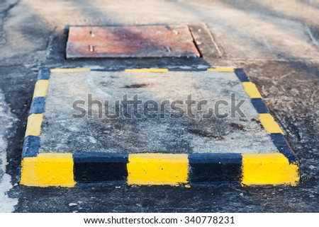 Yellow and black stripes on the concrete surface.