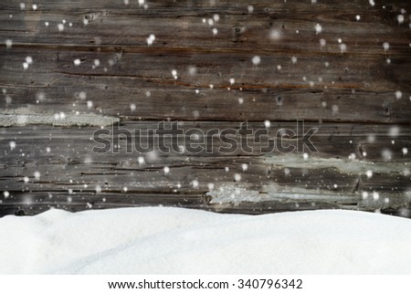 Christmas background with snow and blurred wood texture