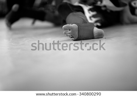 A knockout at the ring, fighter's foot in focus